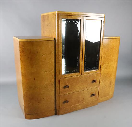 An Art Deco birds eye maple display cabinet and similar dining table,